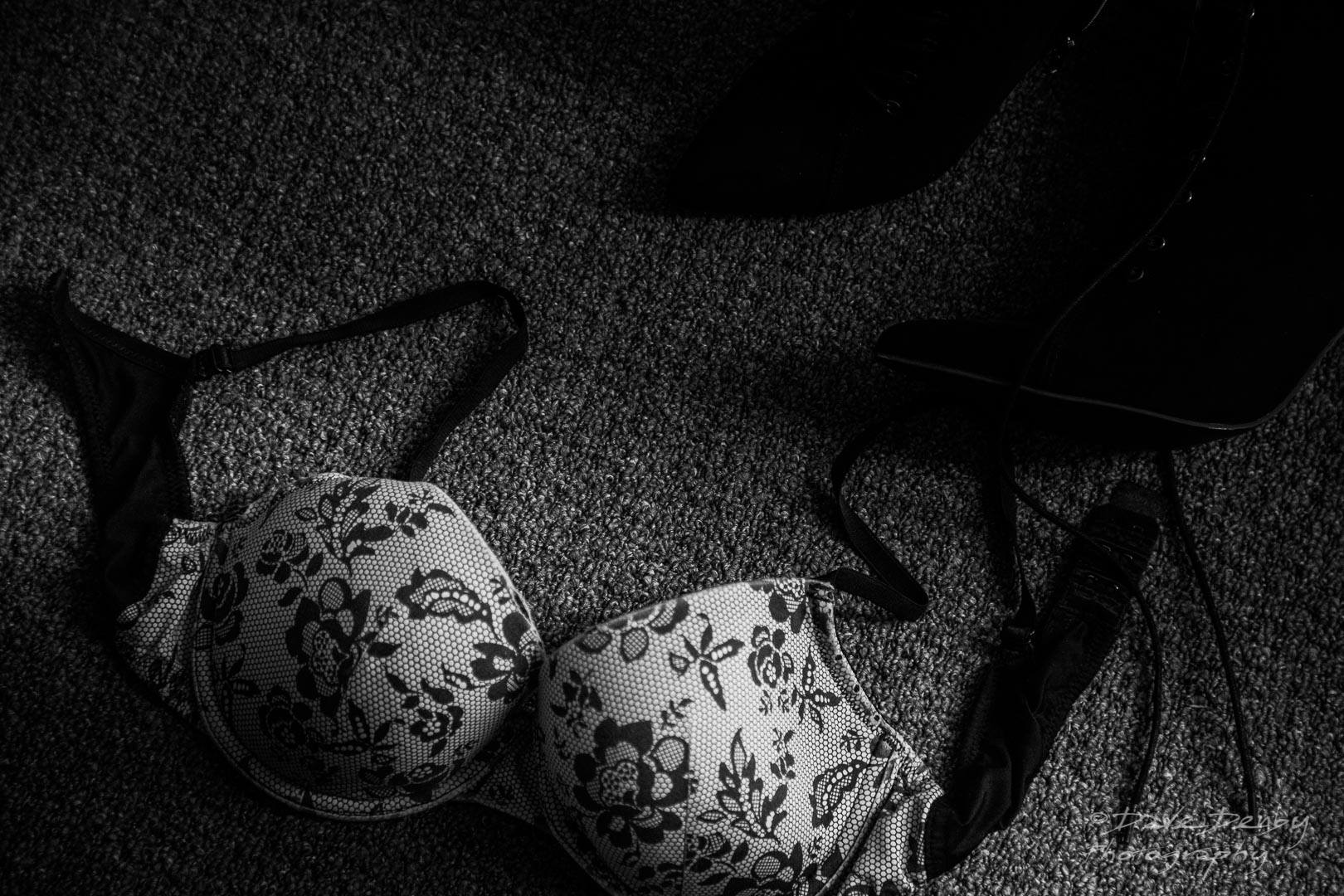 black and white image of a bra on the floor