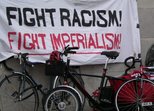 Protest banner reading 'Fight Racism! Fight Imperialism!"