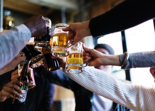 Group of people cheersing with drinks