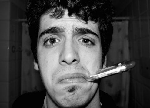 Man Flu Man with Thermometer