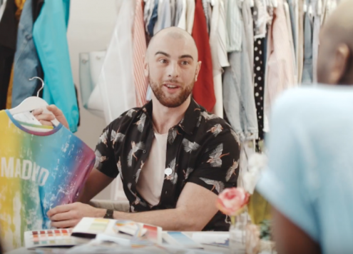 Screenshot from Primark and Stonewall's Pride merch launch featuring a bald and bearded man selling clothes.