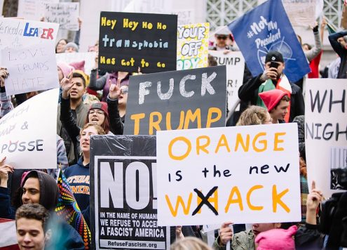 March against Donald Trump and Trump's America, with protest signs such as Fuck Trump and Orange is the New Wack