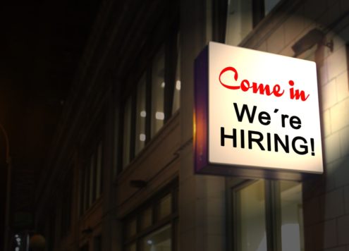 Back-lit sign reading 'Come in, We're HIRING!'